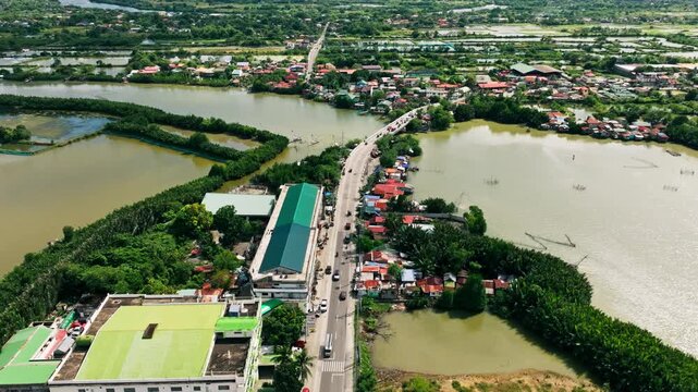 Low altitude aerial view of bridge, highway crossing Basing River in Pangasinan