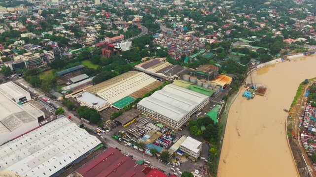 Aerial footage, Marikina River flowing, industrial area, Eastwood, Metro Manila