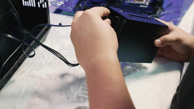 Installing the drive cage with hard drive and SSD into the computer case
