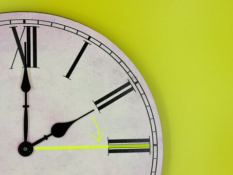 Daylight Saving Time. Two o'clock becomes three o'clock. Clock with a green background. Summer time.