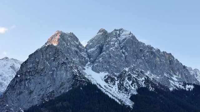 jagged limestone peaks garmisch partenkirchen alps steep rock faces etched snow filled gullies dark pine forests base crisp alpine light up close garmisch-partenkirchen bavaria germany 