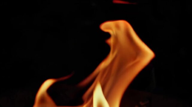A video showcasing a vibrant flame burning brightly in the darkness.