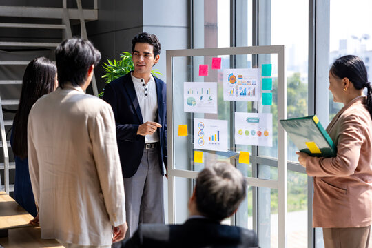 Team of young caucasian entrepreneur have small team meeting for upcoming project for marketing and sale management with skyscraper view for business startup and education
