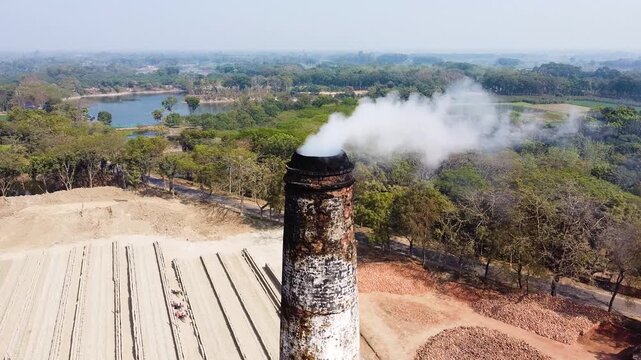 Aerial Drone View of Brick Kiln Production with Smoking Chimney and Workers in Bangladesh