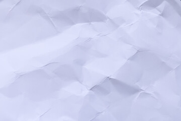Obraz premium Crumpled white paper texture background with subtle lavender tint,High-resolution macro shot of crumpled and wrinkled white paper. The texture features intricate folds, creases, and shadows, creating 
