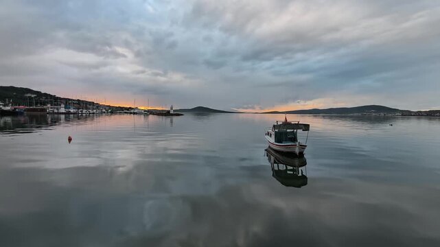 As the sun sets in the quaint and slow Aegean town of Ayvalık, the calm sea and tranquility.
