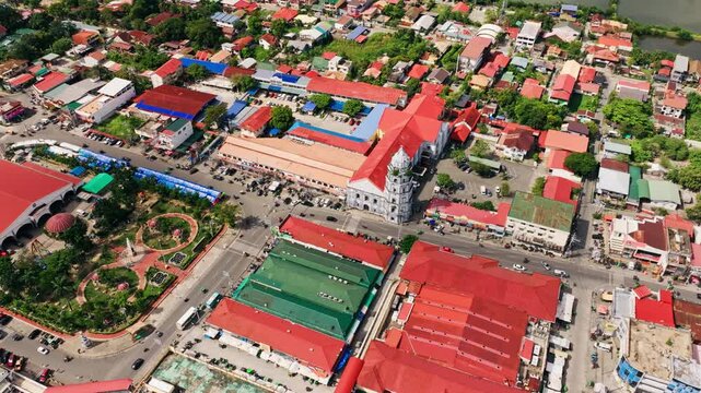 Aerial view, Lingayen Co-Cathedral surrounded by busy streets, colorful rooftops