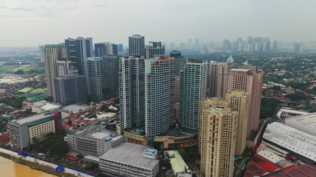 Aerial establishing shot of Eastwood City showing tall buildings, Marikina River