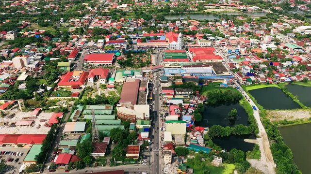 Forward drone establishing shot revealing Lingayen citys, roads, lagoon ponds