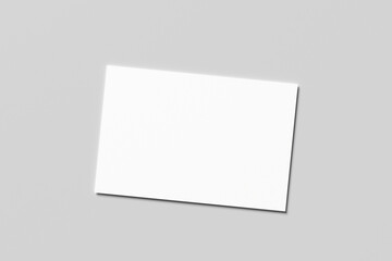 Blank white business card mockup with soft shadows isolated on a minimalist grey background. 3x2 inc