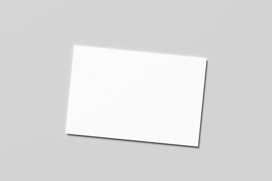 Blank white business card mockup with soft shadows isolated on a minimalist grey background. 3x2 inc