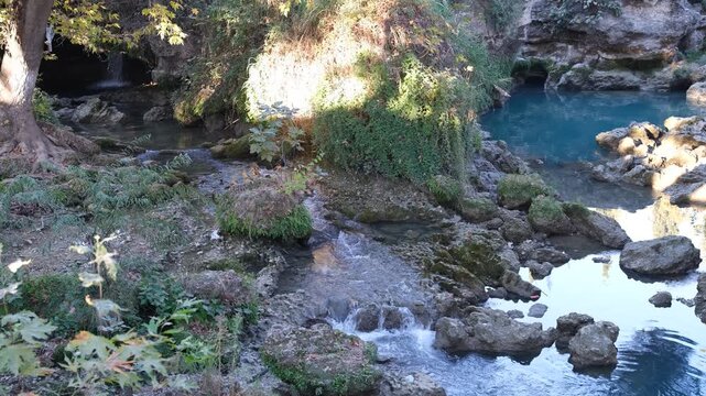 A small spring is flowing. Tarsus waterfall in autumn. Mersin, T&uuml;rkiye. 4k video 