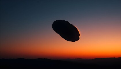 A mysterious flying object soars across the vibrant orange sunset sky.