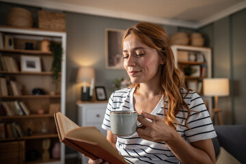 Woman enjoying a cozy moment reading a book at home