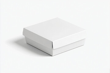 Naklejka premium A white box is placed on a plain surface viewed from an angle.