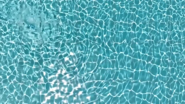Tranquil Turquoise Pool Water with Gentle Ripples and Sunlight Reflections