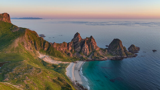 aerial, bird view Amazing rock formations near Matind, M&aring;tind mountain, Otervika Beach near Bleik on Vester&aring;len, vesteralen islands during midnight sun. Sunset, Beautiful hiking destination in arctic 