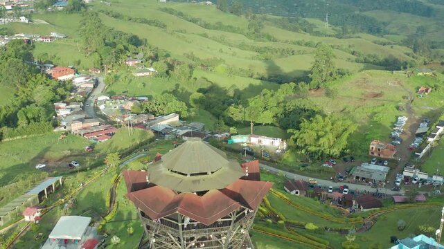 amazinng drone take of the city of filandia quindio colombia exposing artificial balcony of the city looking at the name in huge letters n mountains around the city