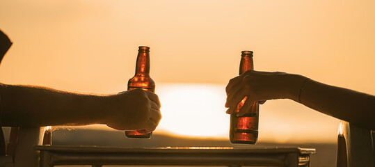 beer bottles in the hands of vacationers, which are held by a couple of lovers or friends. Camping...