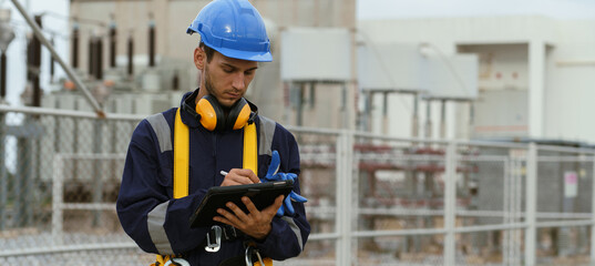 Electrical engineers are checking the operation and power distribution systems within the substation receiving power from the wind farm.  © YaMo