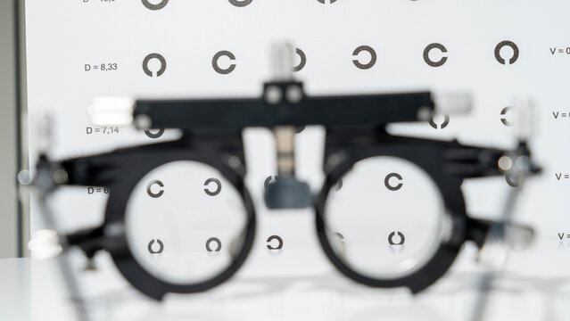Trial eyeglass frame for vision test, half of the glasses prescribed for measuring vision by a doctor with high myopia. Reference information on vision care. . High quality photo