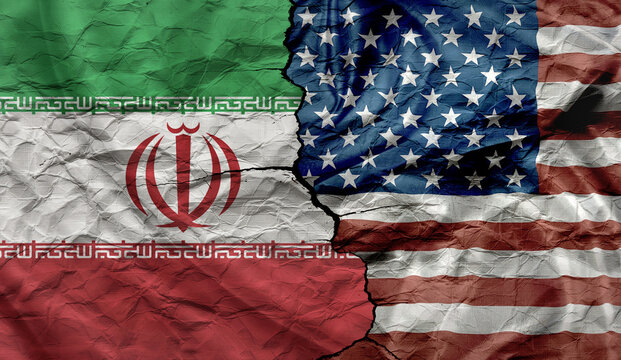 US and Iran flags on a cracked background. Political and military conflict between Iran and the US.