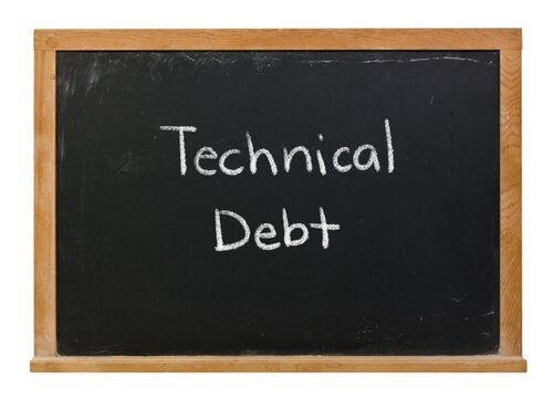 Technical Debt hand written in white chalk on a black chalkboard isolated on white in a wooden frame