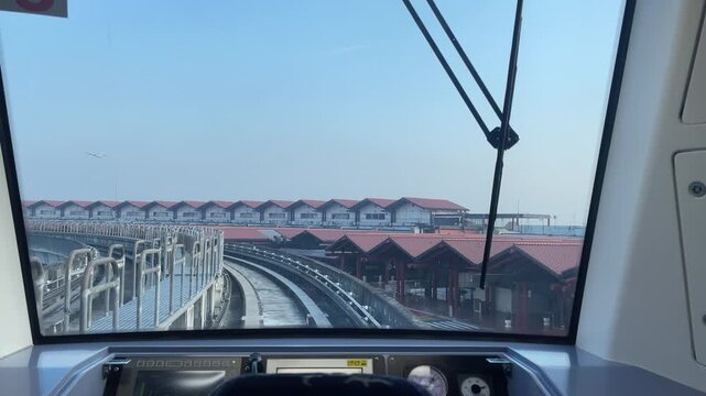 Modern Monorail Driver's Viewpoint Navigating Elevated Tracks Towards Airport Terminal