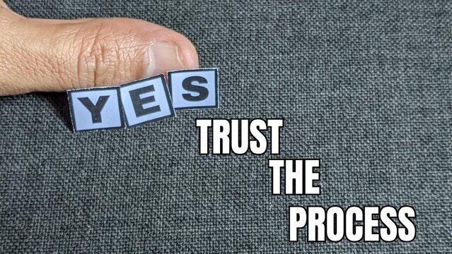 Trust The Process|Three tiles spelling "YES" are held against a background message emphasizing inner strength over mental uncertainty.