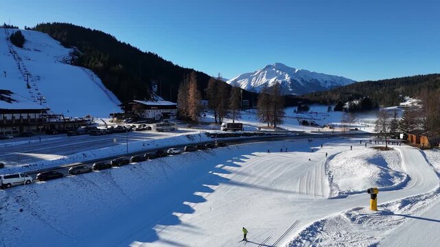perspective sprawling alpine town seefeld diverse mix modern hotels traditional chalets framed by majestic jagged limestone peaks wide drone view tirol austria 