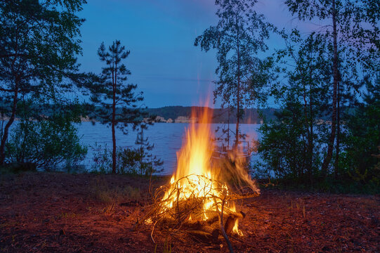 Evening bonfire on the river bank.