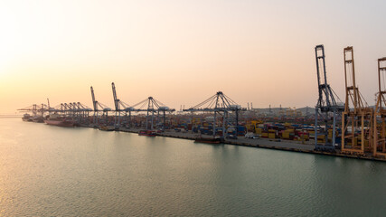 Obraz premium Aerial view Container cargo ship loading unloading container import export sea port, Global trade business container cargo ship freight shipping commercial trade logistic transportation international.