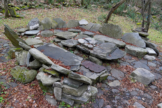A forest recreation area made of fieldstone an ancient megalithic structure a landscape feature wildlife site