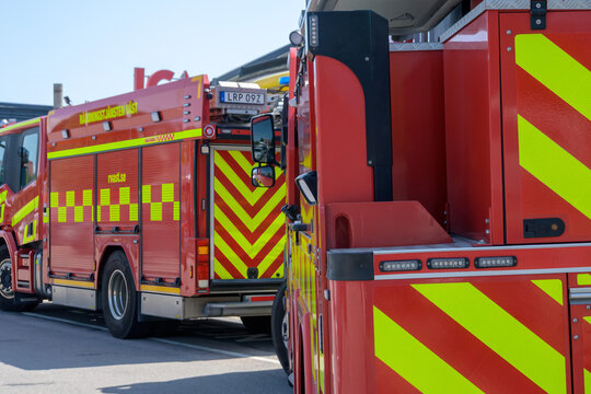 Falkenberg, Sweden, june 19-2025: Two fire trucks parked side by side in a well-lit area, showcasing their bright red and yellow colors. Emergency personnel may be preparing for readiness 