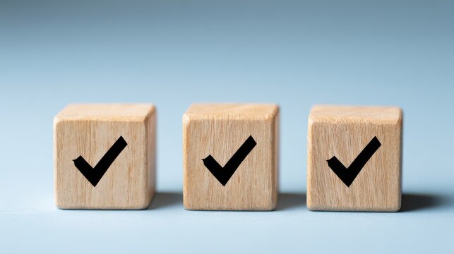 Wooden blocks with check mark symbols arranged in a row on a soft blue background representing approval, success, and positive outcomes in various contexts