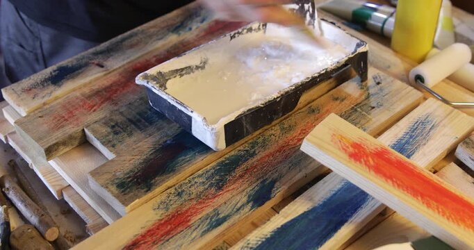 Water based acrylic protective primer coat thinned in plastic pot using paint brush