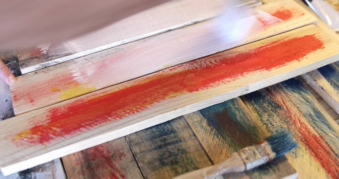 Woodworking diy wood slats painted in white using water based acrylic protective color and hand brush close up