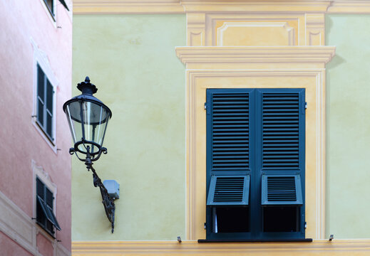 Part of a typical ligurian ornate painted building with street lamp in Chiavari near Genova