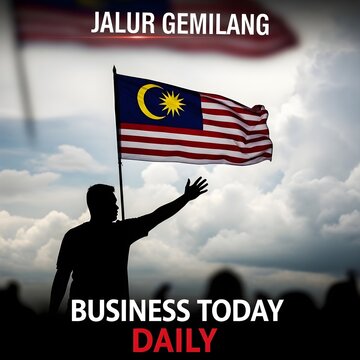 A person raising the malaysian flag jalur gemilang with a crowd present