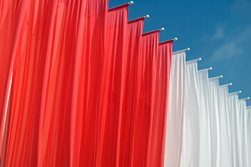 red and white banners hanging at a fair