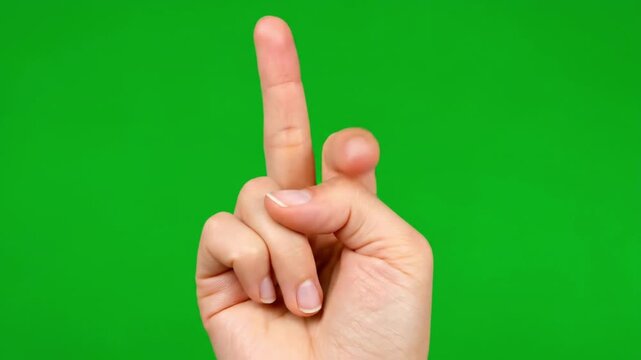 Closeup of clenched fist with green background