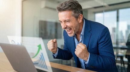 Naklejka premium joyful businessman pumps his fists while viewing rising financial charts on laptop in bright modern office, celebrating professional achievement, positive results, and business growth with enthusiasm