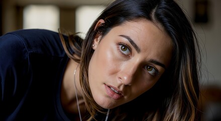 Woman leaning forward with a serious focused expression.