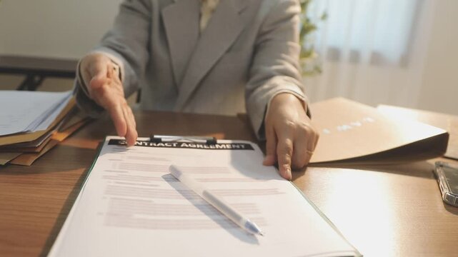 Legal advisor is explaining the offense under the law in the book at office.