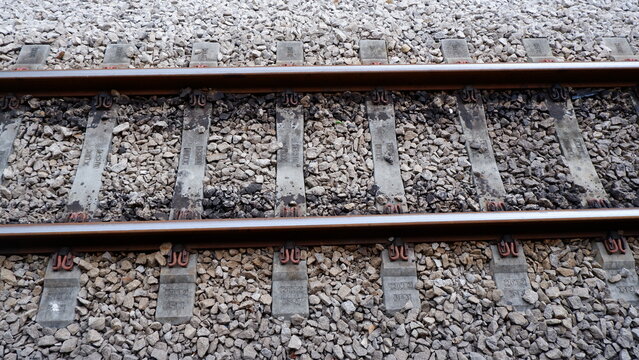 Top View of Railway Tracks with Concrete Sleepers and Grey Stone Ballast