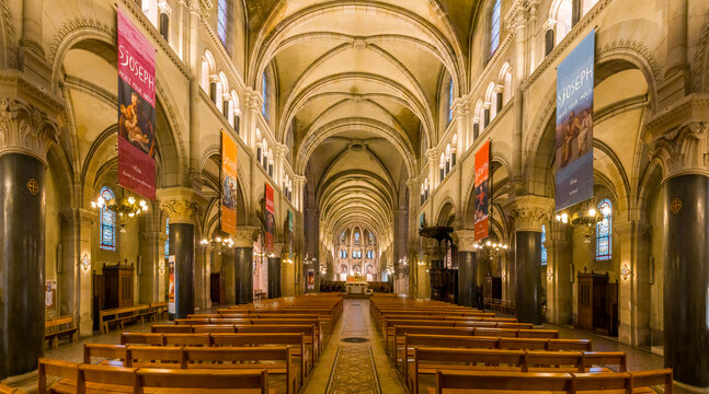 Paris, France - 02 14 2026: Saint Joseph of the Nations Church. Panoramic view of the nave, the aisles with stained glass windows and apse at the back
