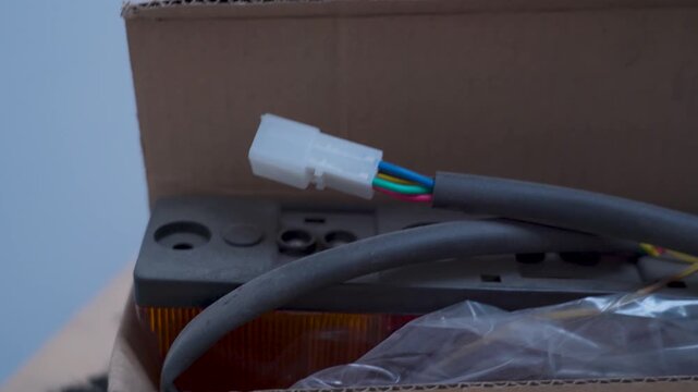 New car tail light assembly unboxing in a cardboard box