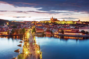 Obraz premium Charles Bridge (Karlův most) in Prague, Czech Republic, spanning the Vltava River with historic towers and Gothic architecture. Panoramic view of the medieval bridge and city skyline, iconic European 