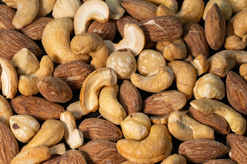 Obraz premium a dense, textured variety of mixed nuts, including smooth cashews and ridged almonds.