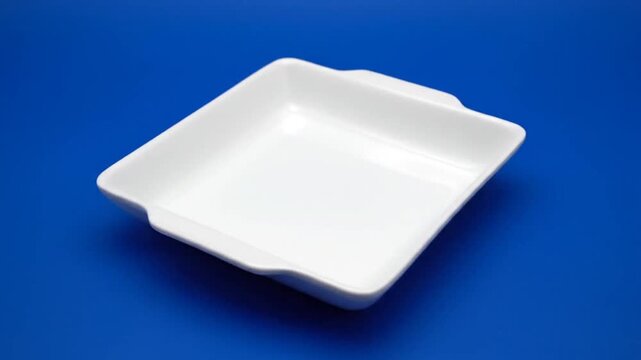 White Ceramic Baking Dish on Blue Background, Kitchenware and Cookware.